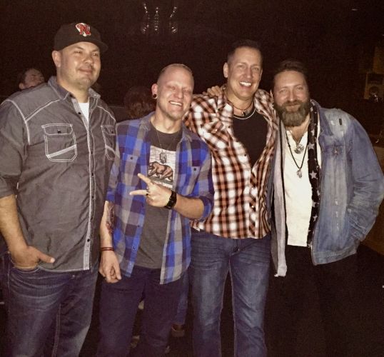Songwriters Shane Grove, Mike Alan, David Wade, and Nolan Neal celebrate after a show where Nolan debuted their song